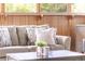 Close-up of a cozy living room featuring natural wood paneling, plush seating, and bright, patterned throw pillows at 2035 Carr St, Lakewood, CO 80214