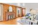 Cozy living room with brick fireplace, wood paneling, and comfortable seating, creating a warm and inviting atmosphere at 2035 Carr St, Lakewood, CO 80214