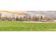 Neighborhood view showcasing a green space, street and other residences at 2035 Carr St, Lakewood, CO 80214