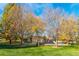 Community playground featuring play structures, a slide and mature trees at 2035 Carr St, Lakewood, CO 80214