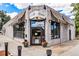 An inviting corner storefront of Suzette Bakery & Cafe with striped awnings and flower planters at 2035 Carr St, Lakewood, CO 80214