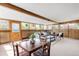 Spacious sunroom with wood paneling, comfortable seating, and lots of windows offering views of the surrounding landscape at 2035 Carr St, Lakewood, CO 80214