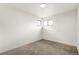 Clean bedroom featuring neutral carpet, and two windows for plenty of natural light at 206 Troy St, Aurora, CO 80011