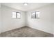 Bright bedroom with two windows and neutral carpeting providing a cozy, comfortable space at 206 Troy St, Aurora, CO 80011