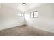 Bright bedroom featuring neutral carpet, and two windows for plenty of natural light at 206 Troy St, Aurora, CO 80011