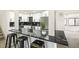 Stylish kitchen featuring a breakfast bar with marble countertops, stainless appliances, and subway tile backsplash at 206 Troy St, Aurora, CO 80011