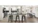 Bright kitchen with stainless steel appliances, a sleek breakfast bar, and an adjacent dining area at 206 Troy St, Aurora, CO 80011