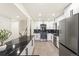 Well-lit kitchen with stainless steel appliances, a marble countertop island, and white cabinets at 206 Troy St, Aurora, CO 80011