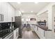 Open kitchen layout with a modern backsplash, stainless steel appliances, and white cabinetry at 206 Troy St, Aurora, CO 80011