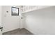 Well-lit laundry room with tile floors, shelving, and a window for natural light at 206 Troy St, Aurora, CO 80011