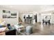 Open-concept living area with wood floors, modern décor, leading to the kitchen and dining areas at 206 Troy St, Aurora, CO 80011