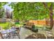 Enjoy outdoor living on this patio, surrounded by a lush garden and mature trees at 11412 W Roxbury Pl, Littleton, CO 80127