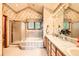 Well-lit bathroom with a large bathtub, shower, and ample counter space at 11412 W Roxbury Pl, Littleton, CO 80127