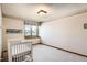 Bright bedroom with a crib, window, and neutral decor, perfect for a Bedroom at 11412 W Roxbury Pl, Littleton, CO 80127