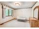 Cozy bedroom featuring a crib, large dresser, and bright window at 11412 W Roxbury Pl, Littleton, CO 80127