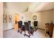 Formal dining room featuring a glass table, seating for four, and a decorative ceiling fan at 11412 W Roxbury Pl, Littleton, CO 80127
