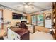 Well-lit home office with built-in shelving, desk, and a view of the outdoors at 11412 W Roxbury Pl, Littleton, CO 80127