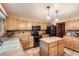 Functional kitchen with wooden cabinetry, a tile backsplash, and black appliances at 11412 W Roxbury Pl, Littleton, CO 80127