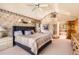 Comfortable main bedroom with ensuite bathroom, ceiling fan and neutral color palette at 11412 W Roxbury Pl, Littleton, CO 80127