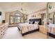 Spacious main bedroom with large window, ceiling fan and neutral color palette at 11412 W Roxbury Pl, Littleton, CO 80127