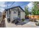 This house has a well-maintained backyard with a grill, patio seating, and space for outdoor dining and entertaining guests at 4456 Yates St, Denver, CO 80212