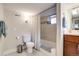 Bathroom featuring shower/bathtub combo and wood vanity with marble countertop at 4456 Yates St, Denver, CO 80212