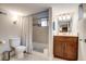 Bathroom with a tiled shower/bathtub and a wood vanity at 4456 Yates St, Denver, CO 80212