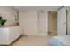 Bedroom features a white dresser, sliding closet doors, and carpet floors at 4456 Yates St, Denver, CO 80212