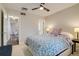 Bright bedroom features ceiling fan, carpet floors, and an open doorway to another room at 4456 Yates St, Denver, CO 80212