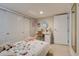 Bedroom features a bed, sliding closet doors, and a vanity table at 4456 Yates St, Denver, CO 80212