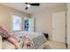 Bright bedroom features a window, closet, white door, and carpet floors at 4456 Yates St, Denver, CO 80212