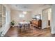 Bright dining area with wood floors, vintage hutch, and an eye-catching light fixture at 4456 Yates St, Denver, CO 80212