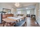 Elegant dining room with modern lighting, wooden table, and seamless flow to living area at 4456 Yates St, Denver, CO 80212