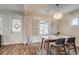 Dining area with wood floors, a decorative light fixture, and a front door view at 4456 Yates St, Denver, CO 80212