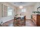 Bright dining area with wood floors, vintage hutch, and an eye-catching light fixture at 4456 Yates St, Denver, CO 80212