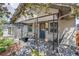 Charming covered front porch with seating area and decorative wrought iron details at 4456 Yates St, Denver, CO 80212