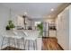 Open kitchen with bar seating, stainless steel appliances, and bright white cabinetry at 4456 Yates St, Denver, CO 80212