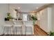 Open kitchen with bar seating, stainless steel appliances, and bright white cabinetry at 4456 Yates St, Denver, CO 80212