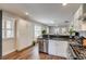 Bright kitchen with stainless steel appliances, white cabinets, and hardwood floors at 4456 Yates St, Denver, CO 80212