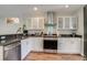 Modern kitchen featuring stainless steel appliances, white cabinets, and sleek countertops at 4456 Yates St, Denver, CO 80212