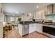 Open kitchen with stainless steel appliances, stylish cabinets and lots of natural light at 4456 Yates St, Denver, CO 80212