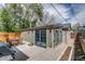 Exterior view of the backyard office featuring a patio with a wooden table and chairs at 4456 Yates St, Denver, CO 80212