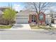 Charming single-Gathering home with a well-manicured front yard and an attached two-car garage at 7141 S Versailles St, Aurora, CO 80016