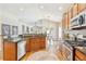 Spacious kitchen with stainless steel appliances, granite counters, and hardwood floors at 7141 S Versailles St, Aurora, CO 80016