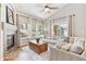 Comfortable living room with vaulted ceilings, a fireplace, and large windows offering natural light at 7141 S Versailles St, Aurora, CO 80016