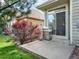 Backyard patio area featuring a stainless steel gas grill, grass, red bushes, and steps to the patio at 11556 W Cooper Pl, Littleton, CO 80127