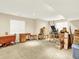 Unfinished basement area with carpet, and loaded with moving boxes and furniture at 11556 W Cooper Pl, Littleton, CO 80127