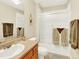 Bathroom featuring a glass-enclosed shower, neutral-colored tile, and a vanity with ample storage at 11556 W Cooper Pl, Littleton, CO 80127