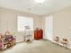 Bedroom with play grocery store cart, dresser, light-colored walls, and carpet at 11556 W Cooper Pl, Littleton, CO 80127