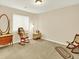 Bedroom with rocking chair and antique dresser with mirror and neutral carpet at 11556 W Cooper Pl, Littleton, CO 80127